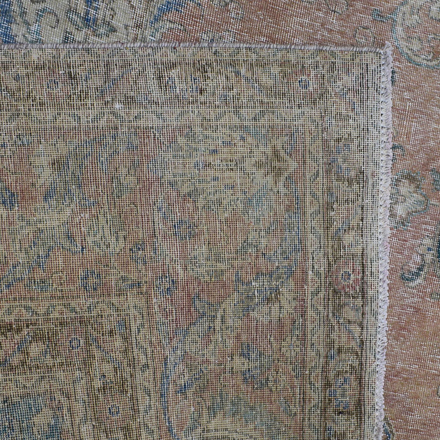 Backside of hand knotted Persian rug showing weave structure and authentic handmade construction