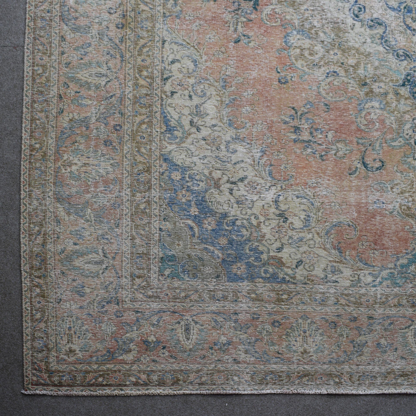Corner detail of Persian rug with decorative border and traditional Persian floral motifs
