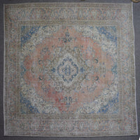 Macro close up of Persian rug pile showing worn wool texture and faded pattern