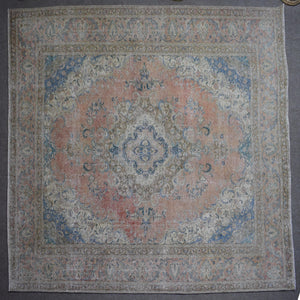 Macro close up of Persian rug pile showing worn wool texture and faded pattern