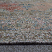 Detailed view of Persian rug medallion highlighting blue ornamental motifs and vintage patina