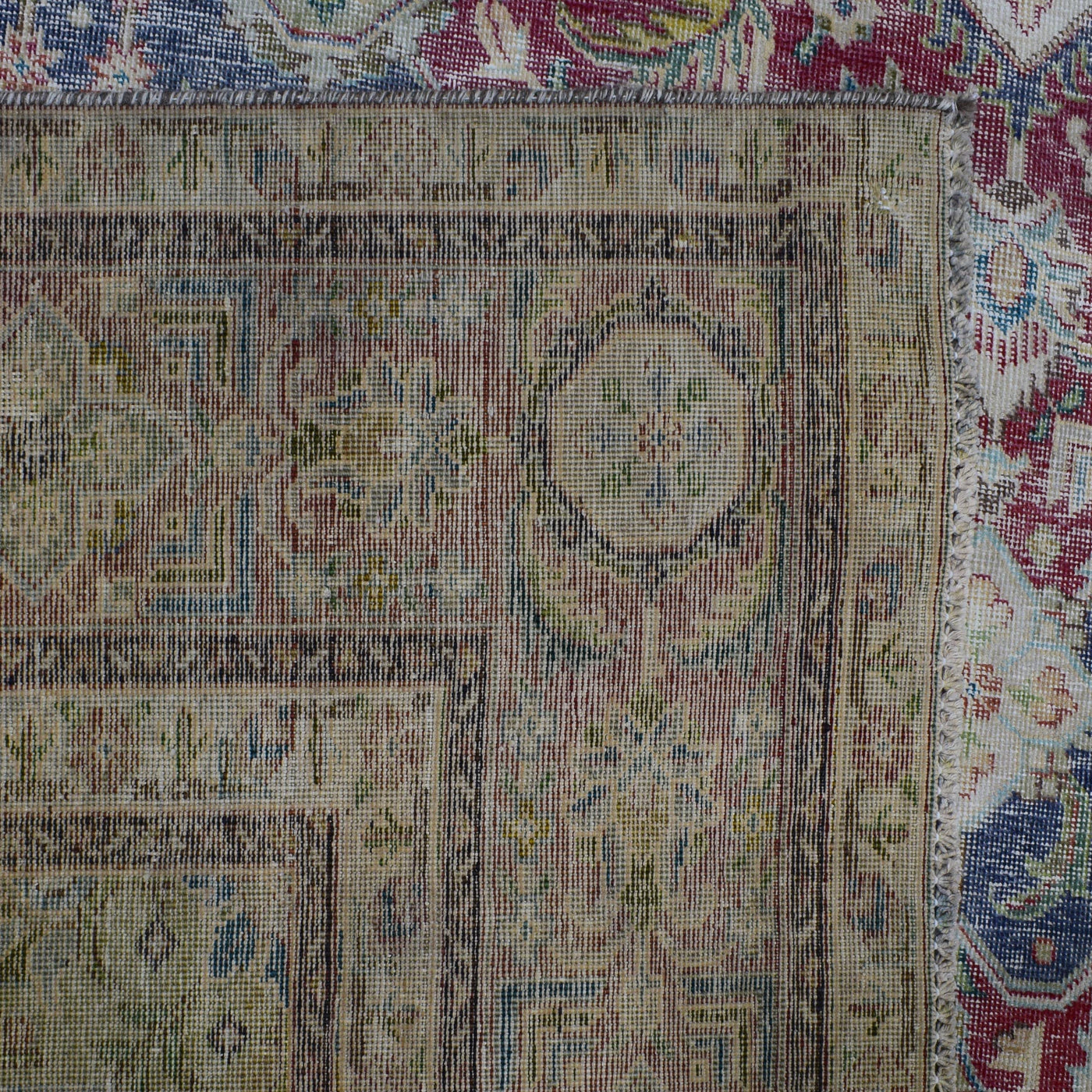 Backside of hand knotted Persian rug showing weave structure and authentic handmade construction