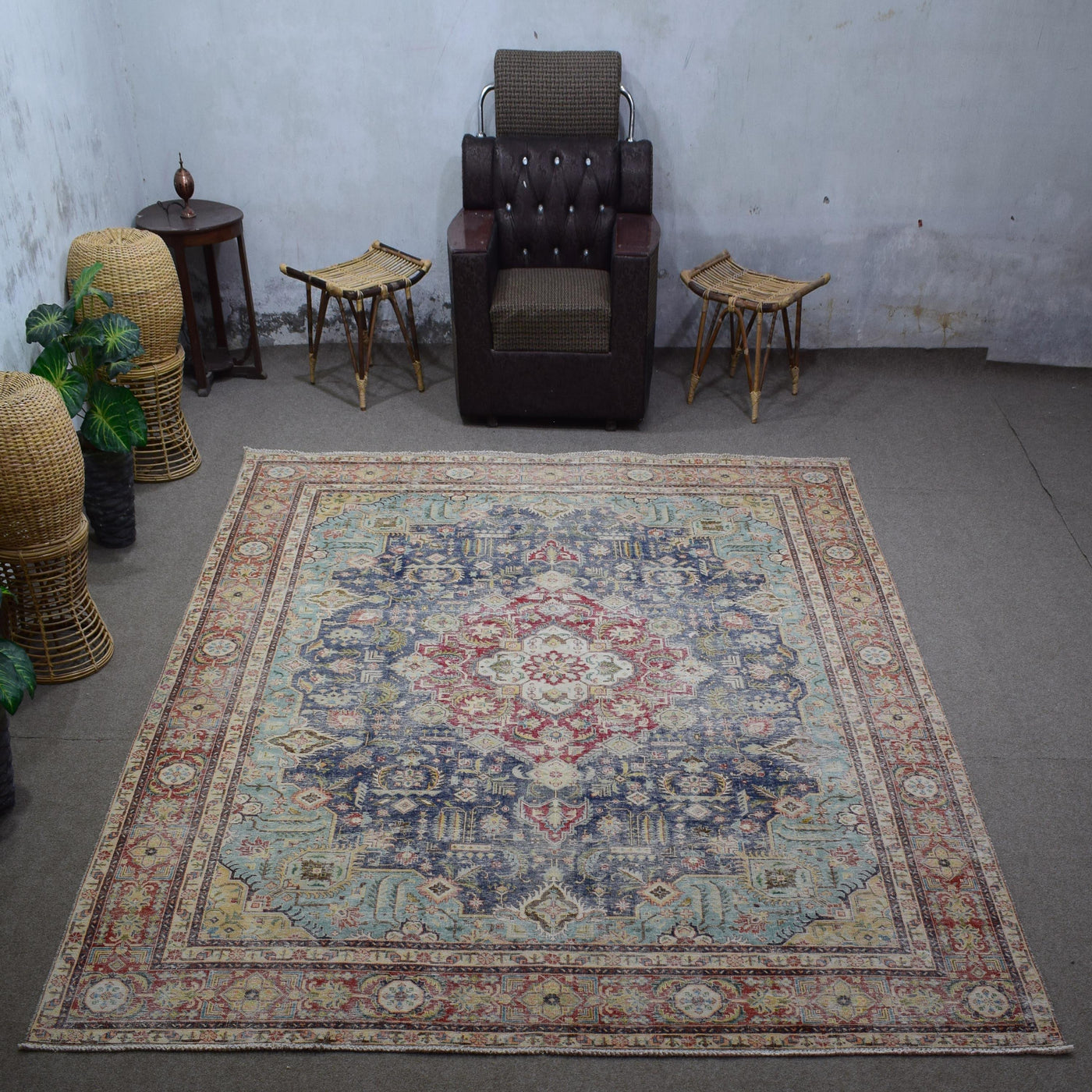 Large distressed vintage Persian rug 288x380 cm styled in interior showing navy background and ornate medallion design