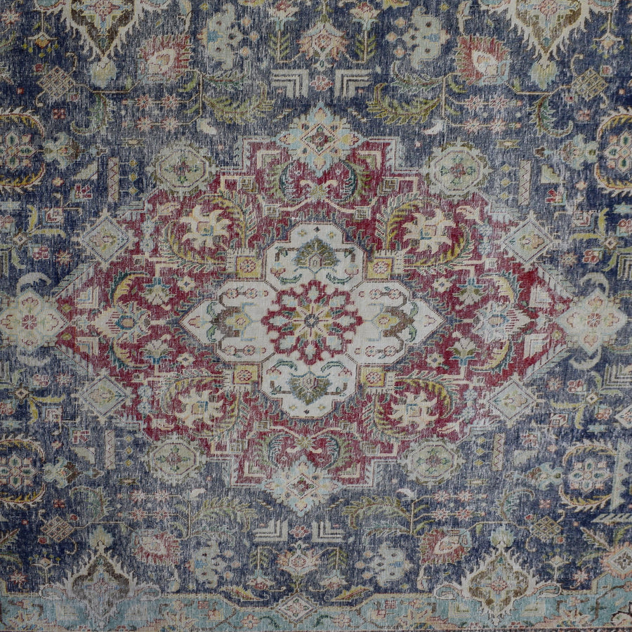 Detailed view of vintage Persian rug medallion featuring traditional Persian floral patterns on navy field