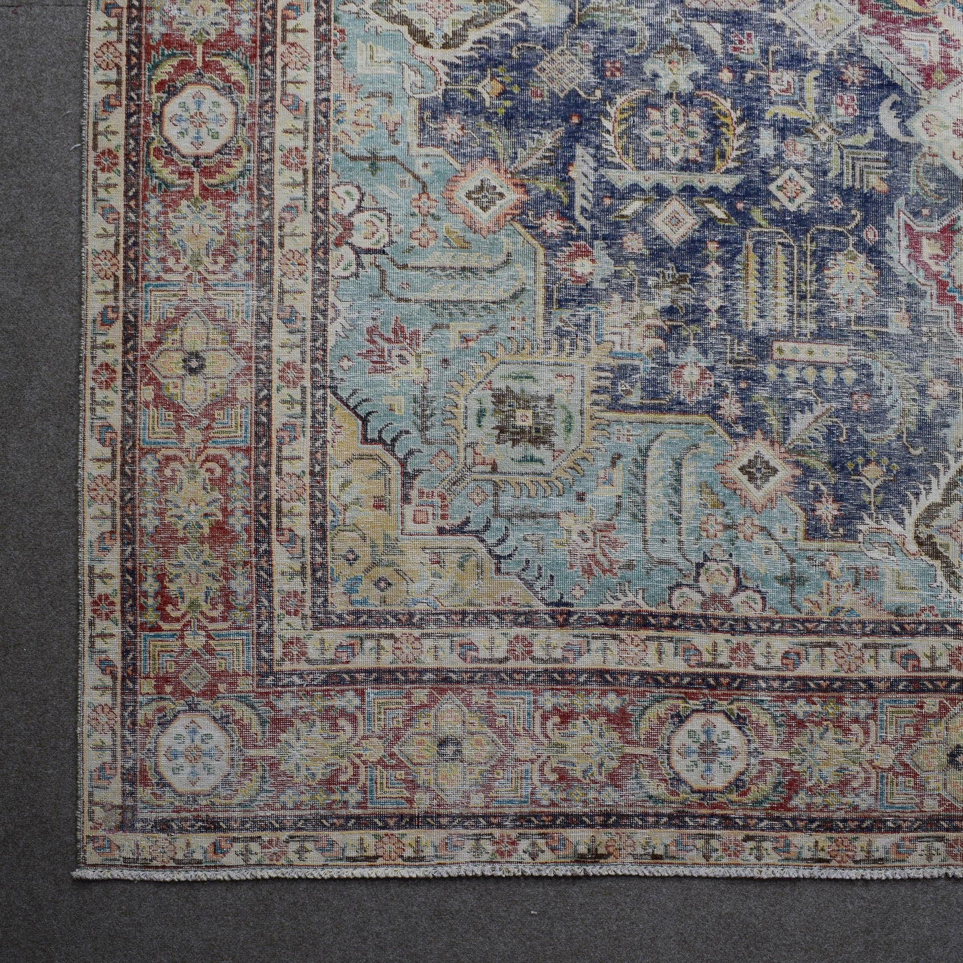 Corner detail of Persian rug with decorative border and classic Persian motifs