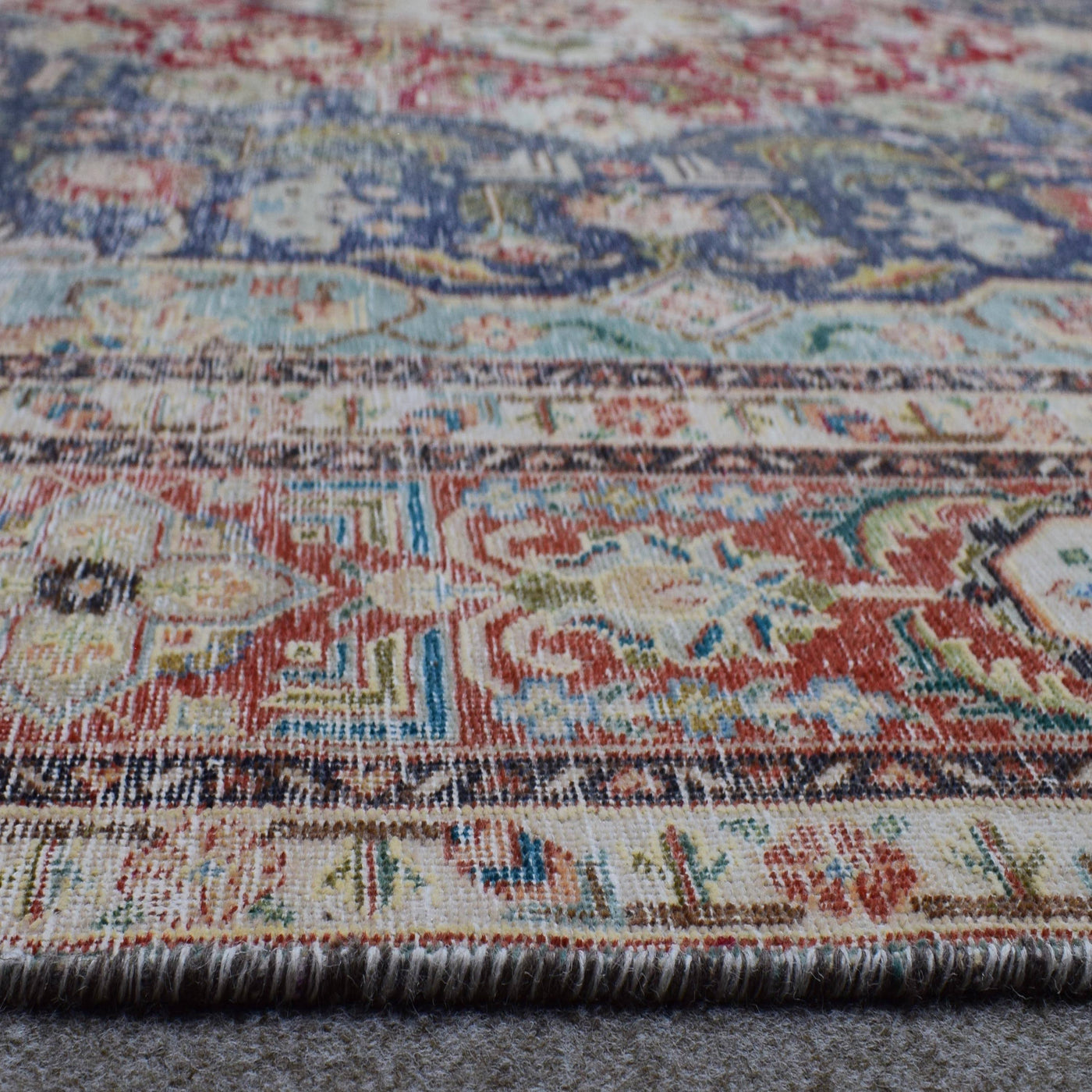 Macro detail of Persian rug medallion highlighting dense floral elements and wool texture