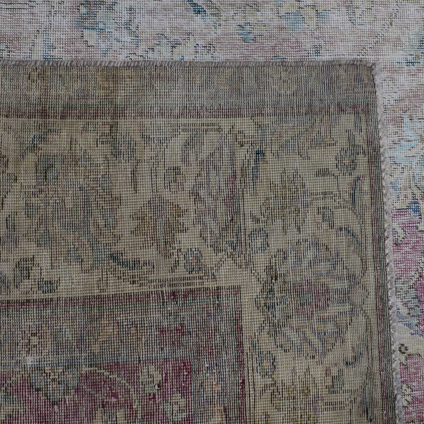Backside of hand knotted Persian rug showing weave structure and authentic handmade construction
