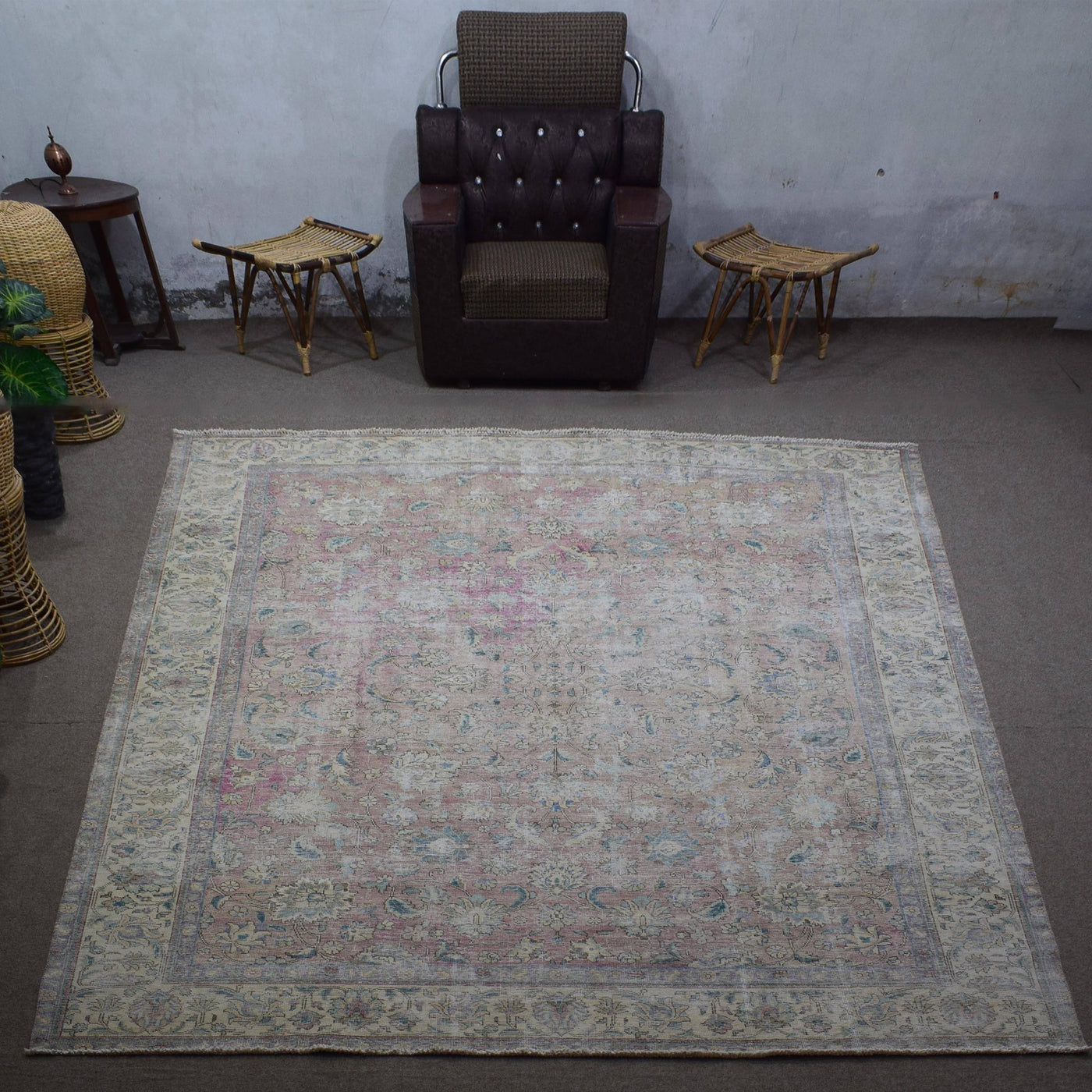 Large distressed vintage Persian rug 292x378 cm styled in interior showing soft neutral tones and worn floral design