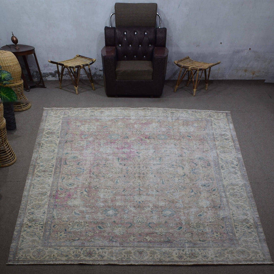 Large distressed vintage Persian rug 292x378 cm styled in interior showing soft neutral tones and worn floral design