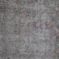 Detailed view of vintage Persian rug pattern featuring delicate floral elements and distressed texture