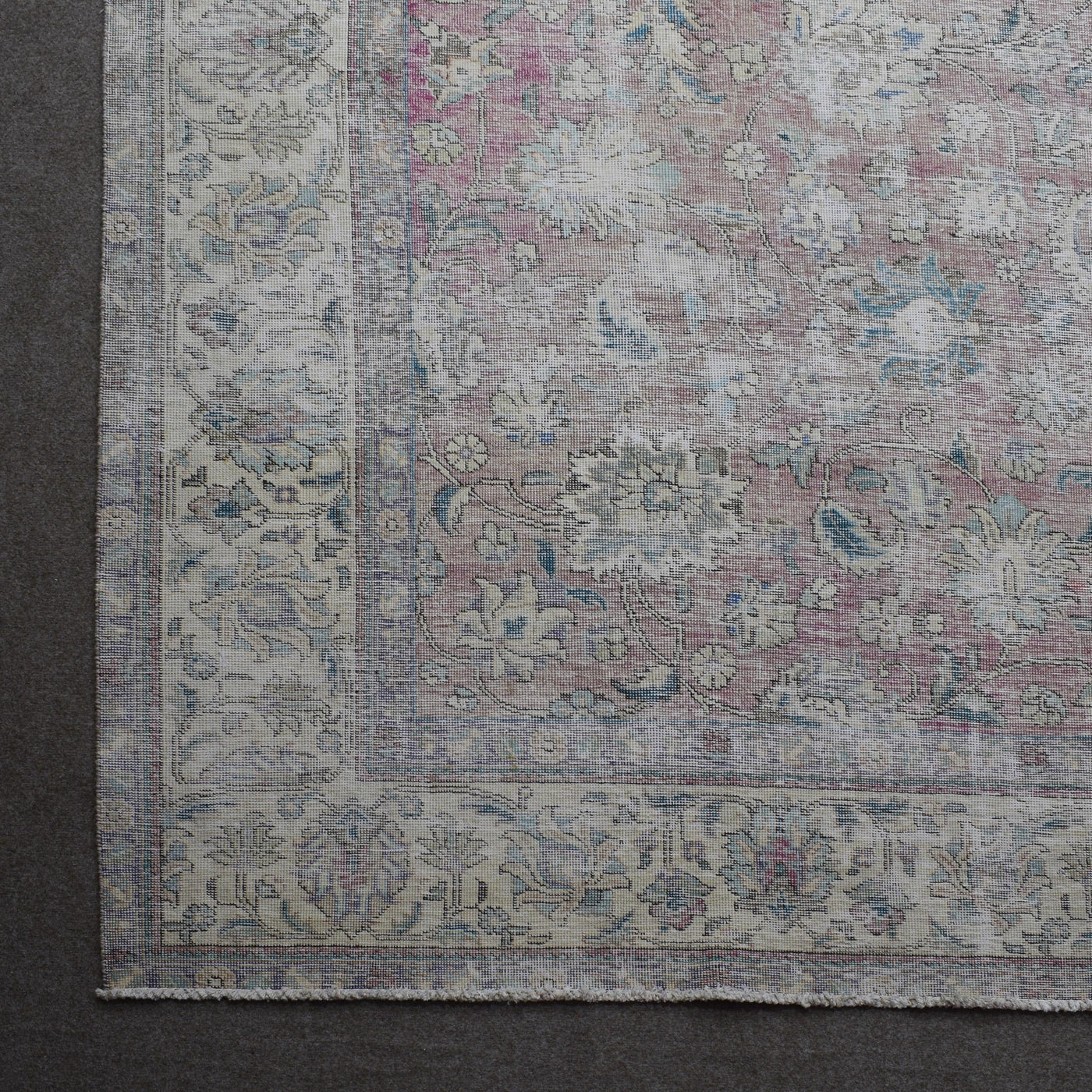 Corner detail of Persian rug with decorative border and traditional Persian motifs