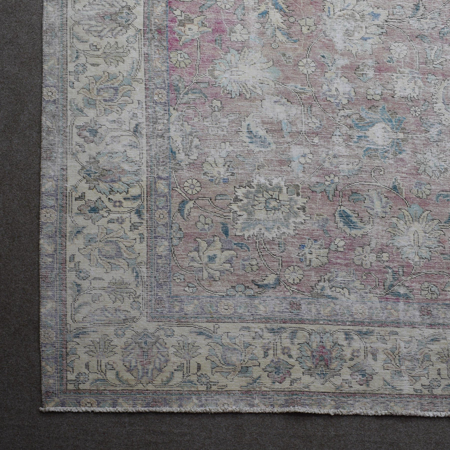Corner detail of Persian rug with decorative border and traditional Persian motifs
