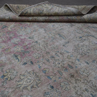 Detailed view of Persian rug floral pattern highlighting soft pastel tones and distressed finish