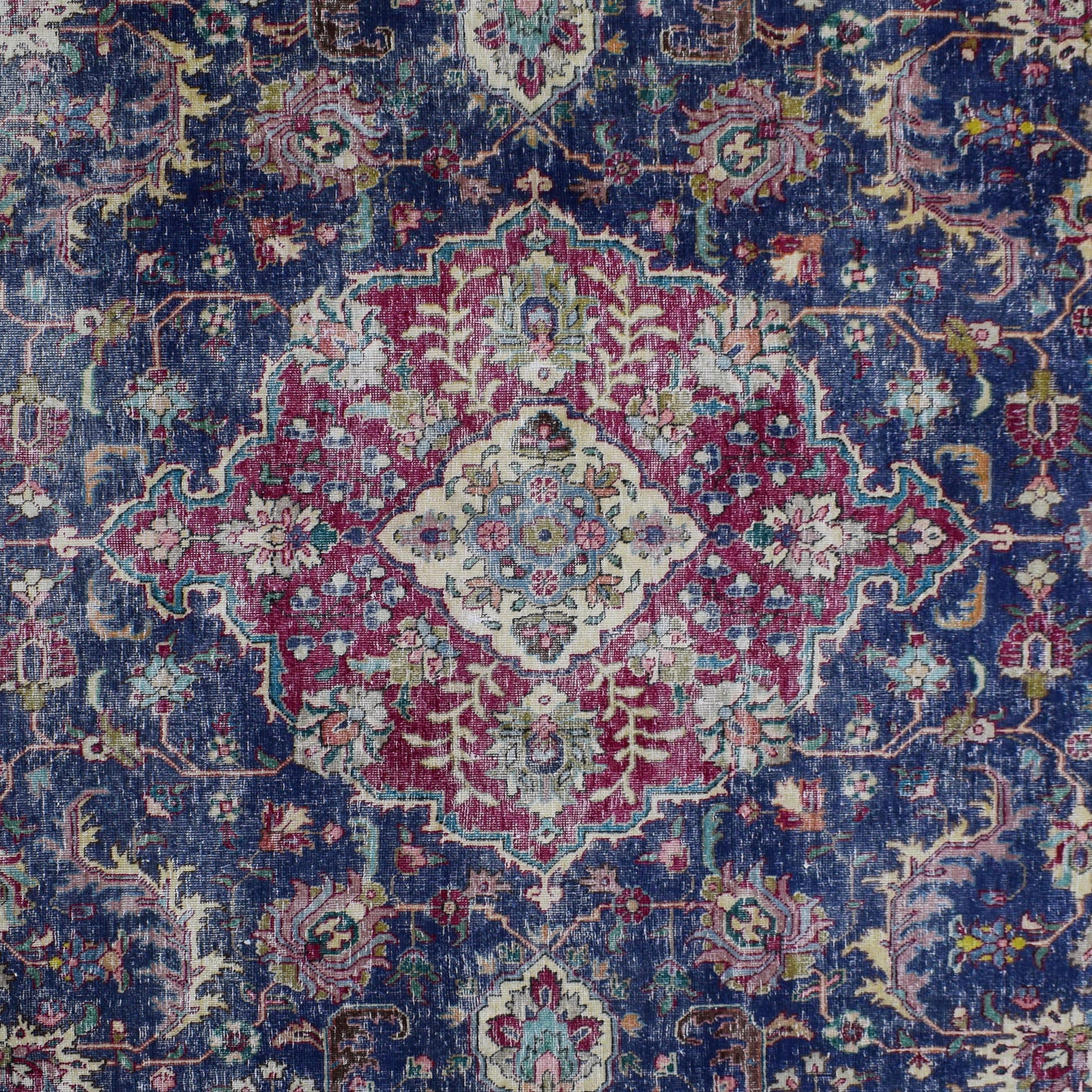 Detailed view of vintage Persian rug medallion featuring traditional Persian floral design on navy field