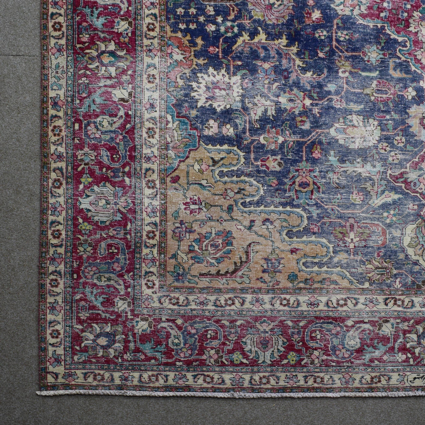 Corner detail of Persian rug with decorative border and classic Persian motifs