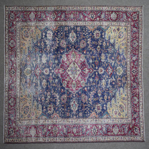 Close up of Persian rug border with colorful floral motifs and intricate guard stripes