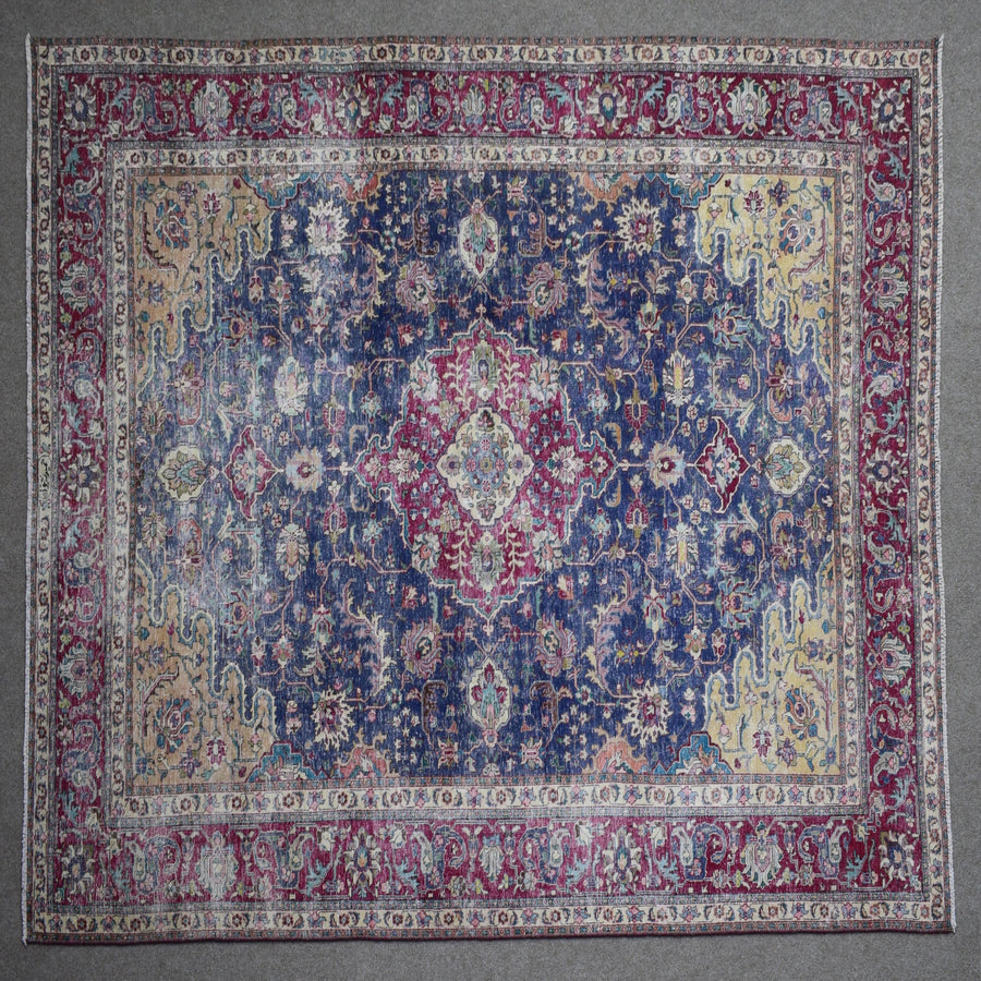 Close up of Persian rug border with colorful floral motifs and intricate guard stripes