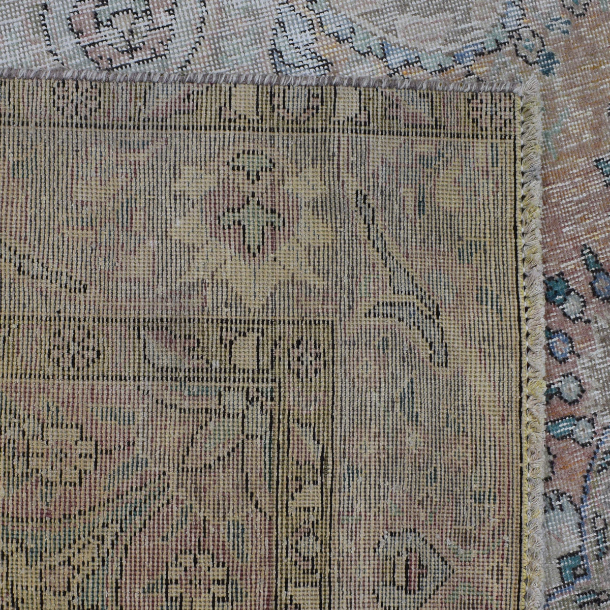 Backside of hand knotted Persian rug showing weave structure and authentic handmade construction