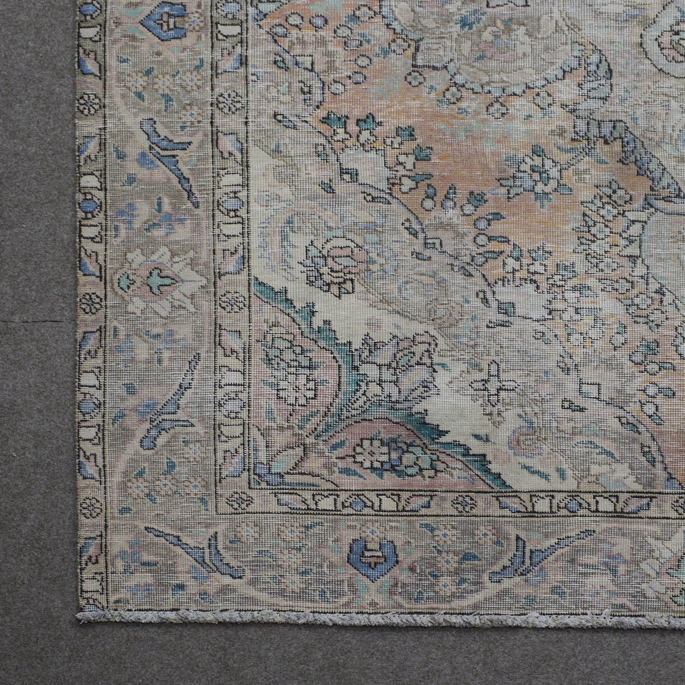 Corner detail of Persian rug with decorative border and classic Persian floral motifs