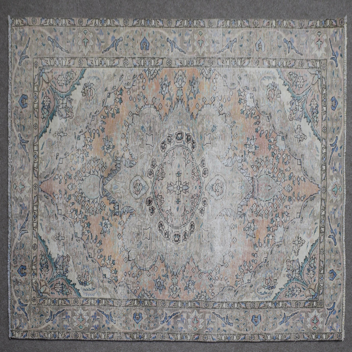 Close up of Persian rug border with blue floral motifs and intricate guard stripes