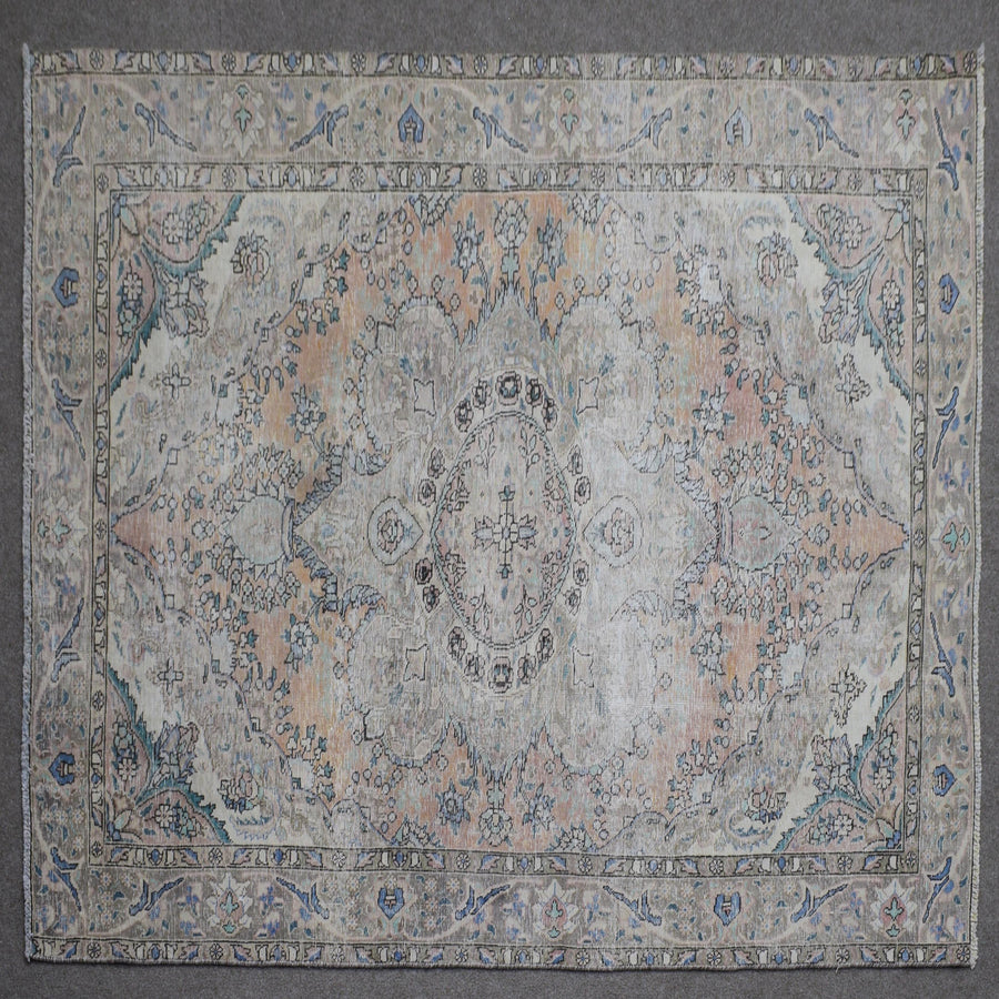 Close up of Persian rug border with blue floral motifs and intricate guard stripes