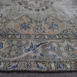 Macro detail of Persian rug medallion highlighting delicate floral elements and wool texture
