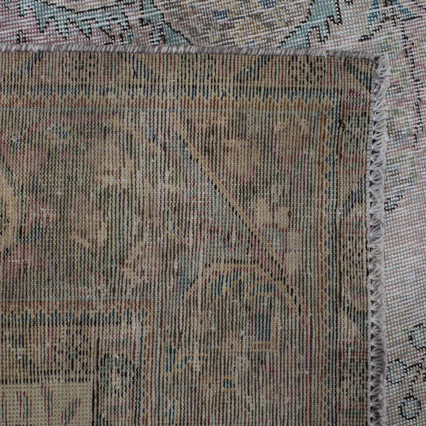Backside of hand knotted Persian rug showing weave structure and authentic handmade construction