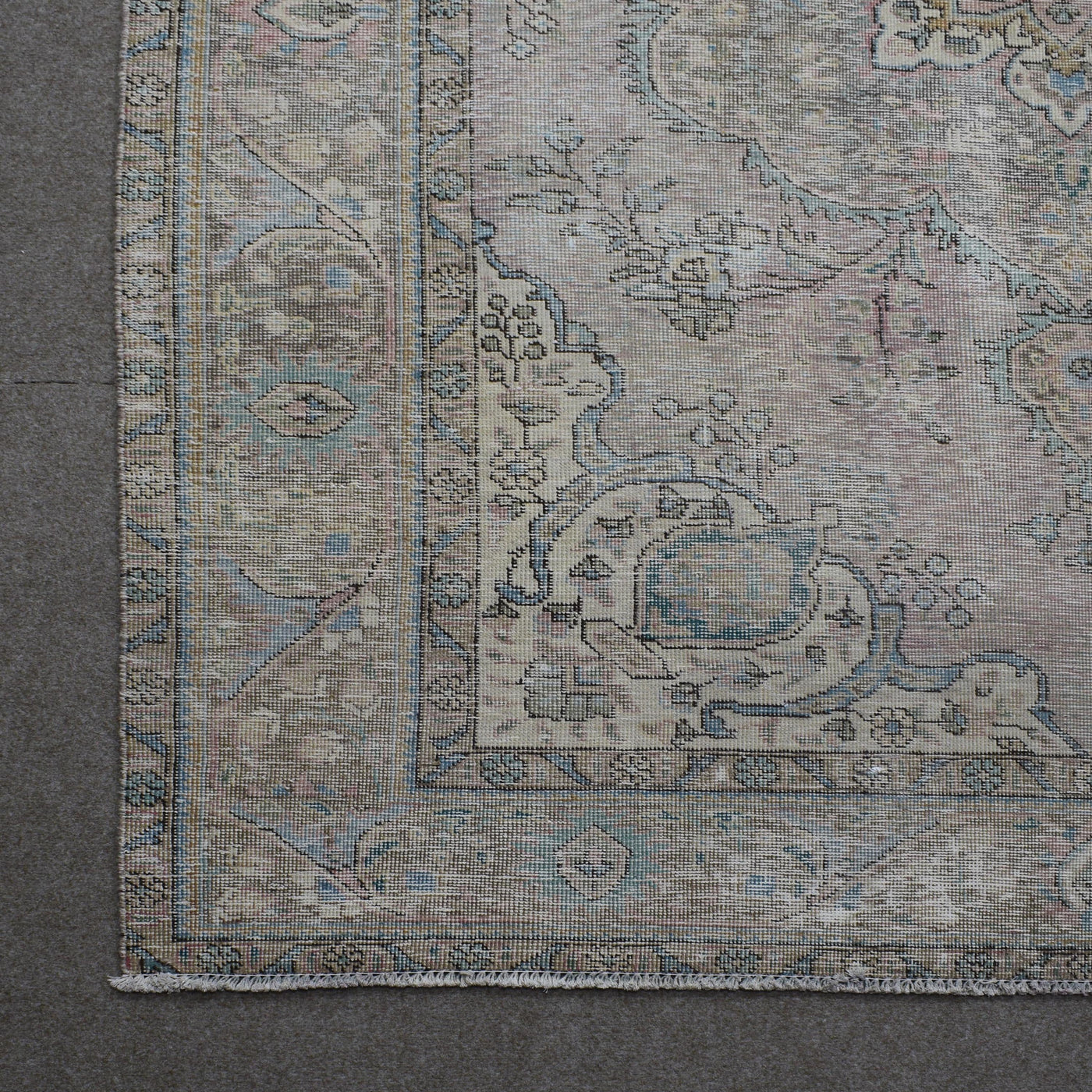 Corner detail of Persian rug with decorative border and traditional Persian motifs