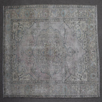 Close up of Persian rug border with subtle blue floral motifs and guard stripes