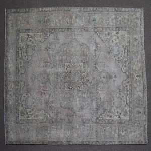 Close up of Persian rug border with subtle blue floral motifs and guard stripes