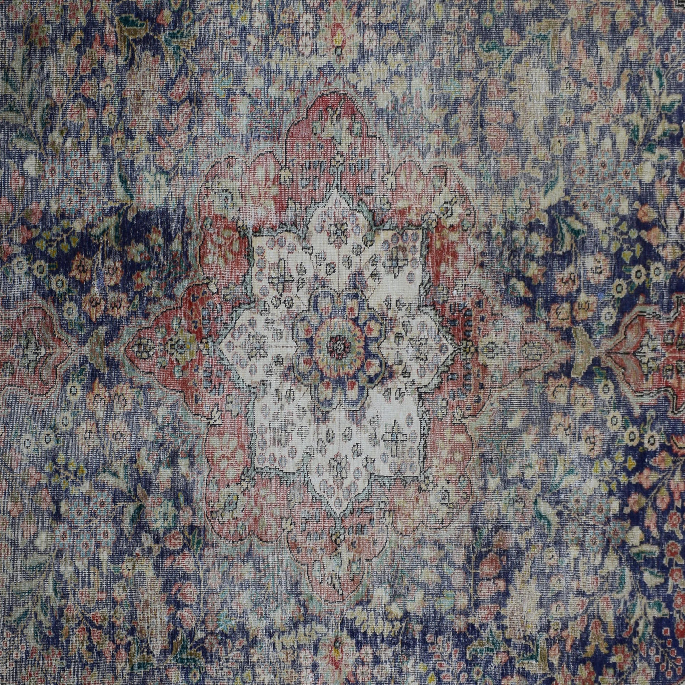 Detailed view of vintage Persian rug medallion featuring traditional Persian floral patterns