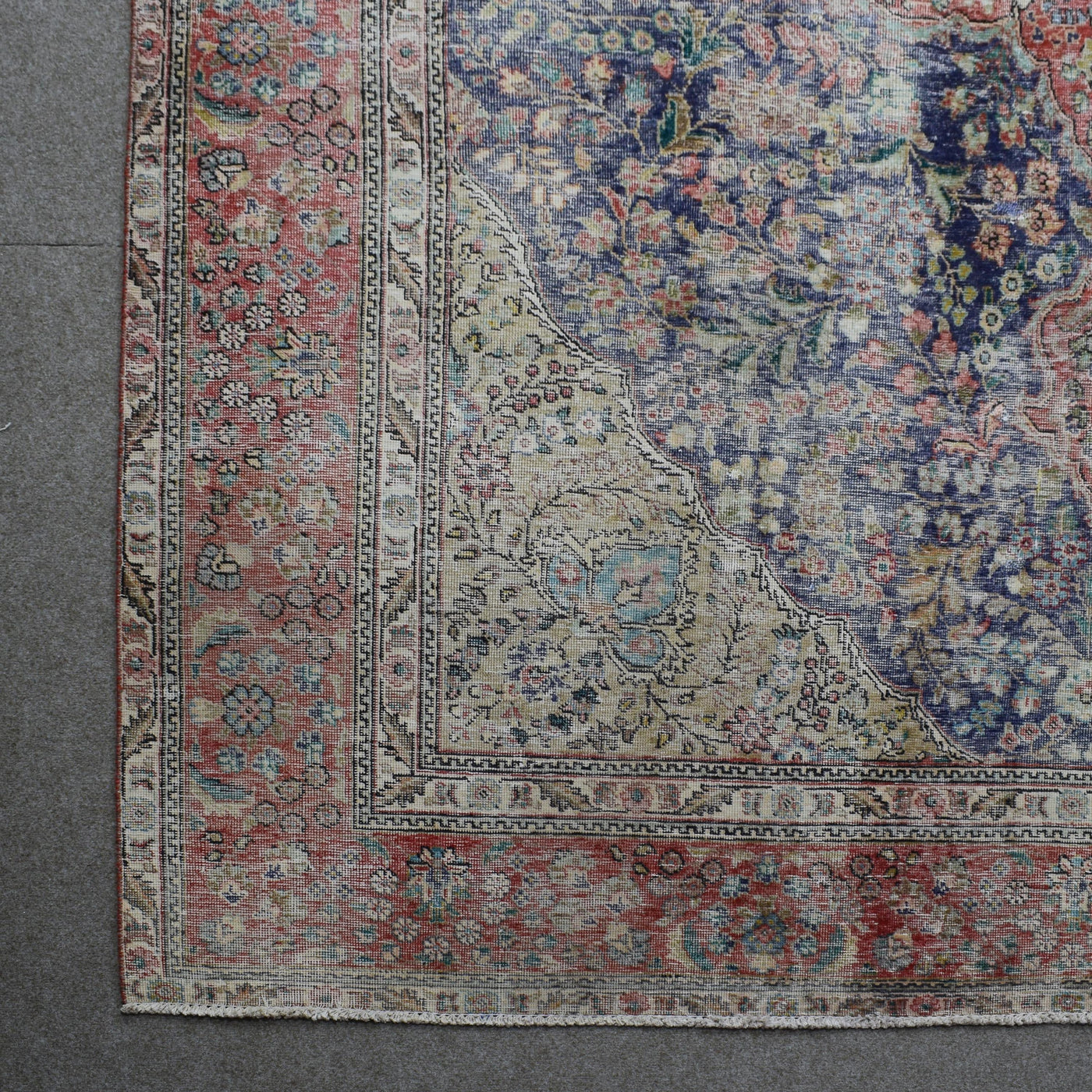 Corner detail of Persian rug with decorative border and traditional Persian motifs