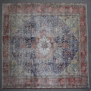 Close up of Persian rug border with colorful floral motifs and intricate guard stripes