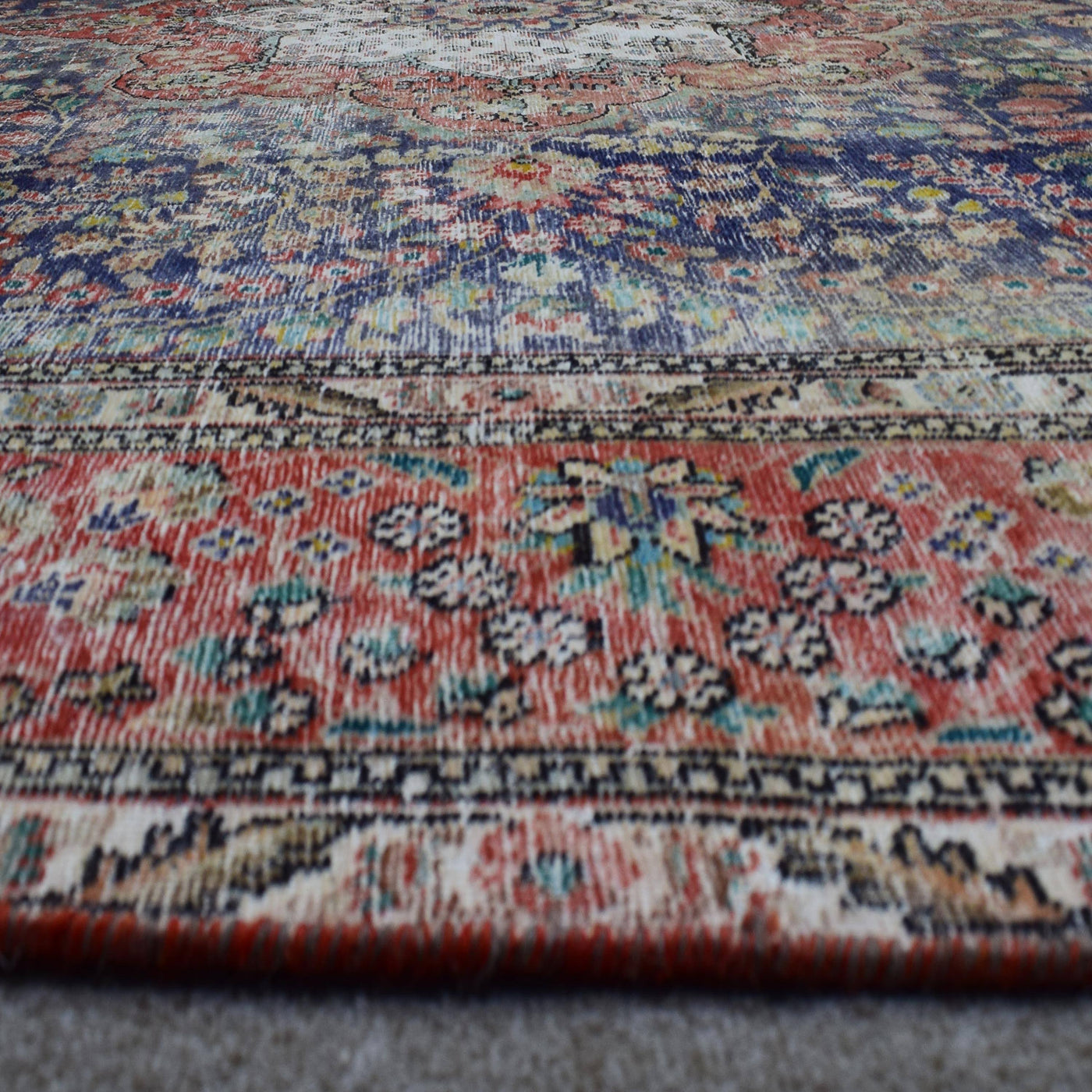Macro detail of Persian rug medallion highlighting dense floral elements and wool texture