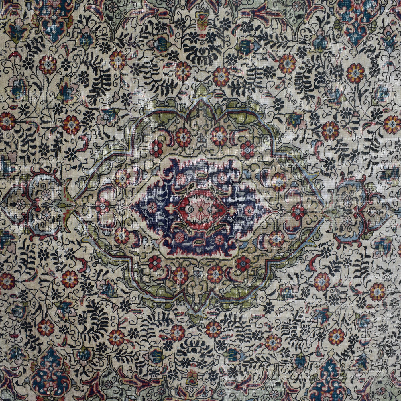 Detailed view of vintage Persian rug medallion featuring traditional Persian floral patterns on ivory field