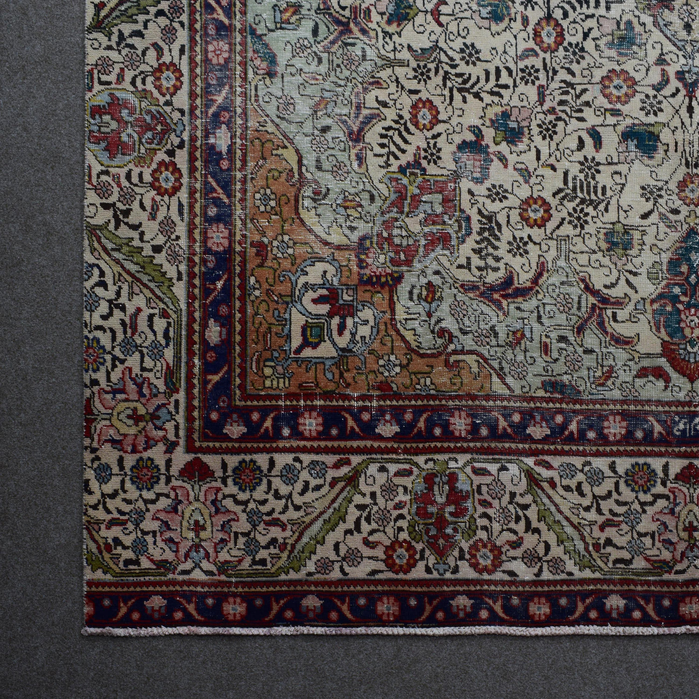 Corner detail of Persian rug with decorative border and classic Persian motifs