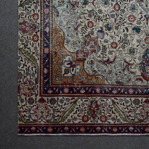 Corner detail of Persian rug with decorative border and classic Persian motifs