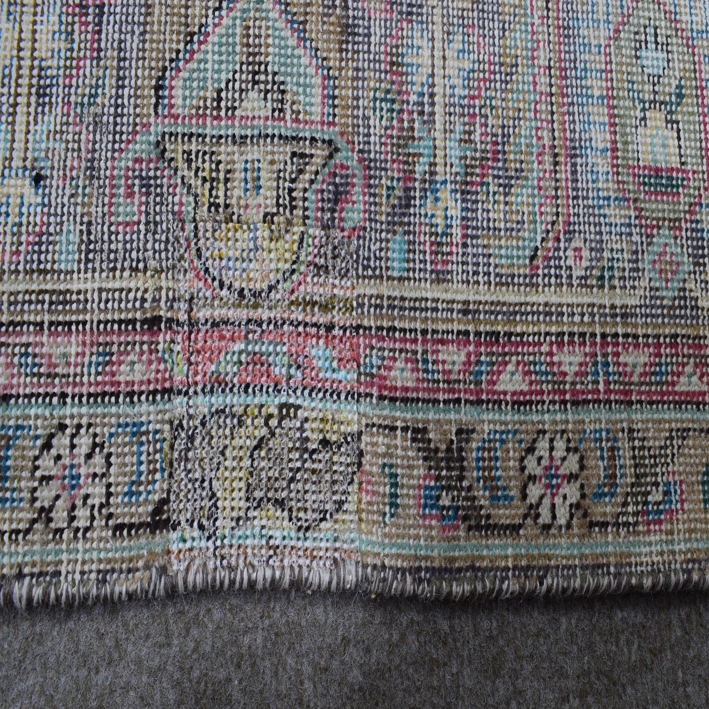 Backside of hand knotted Persian rug showing weave structure and authentic handmade construction