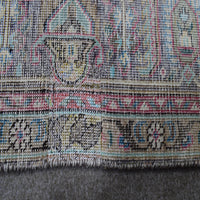 Backside of hand knotted Persian rug showing weave structure and authentic handmade construction
