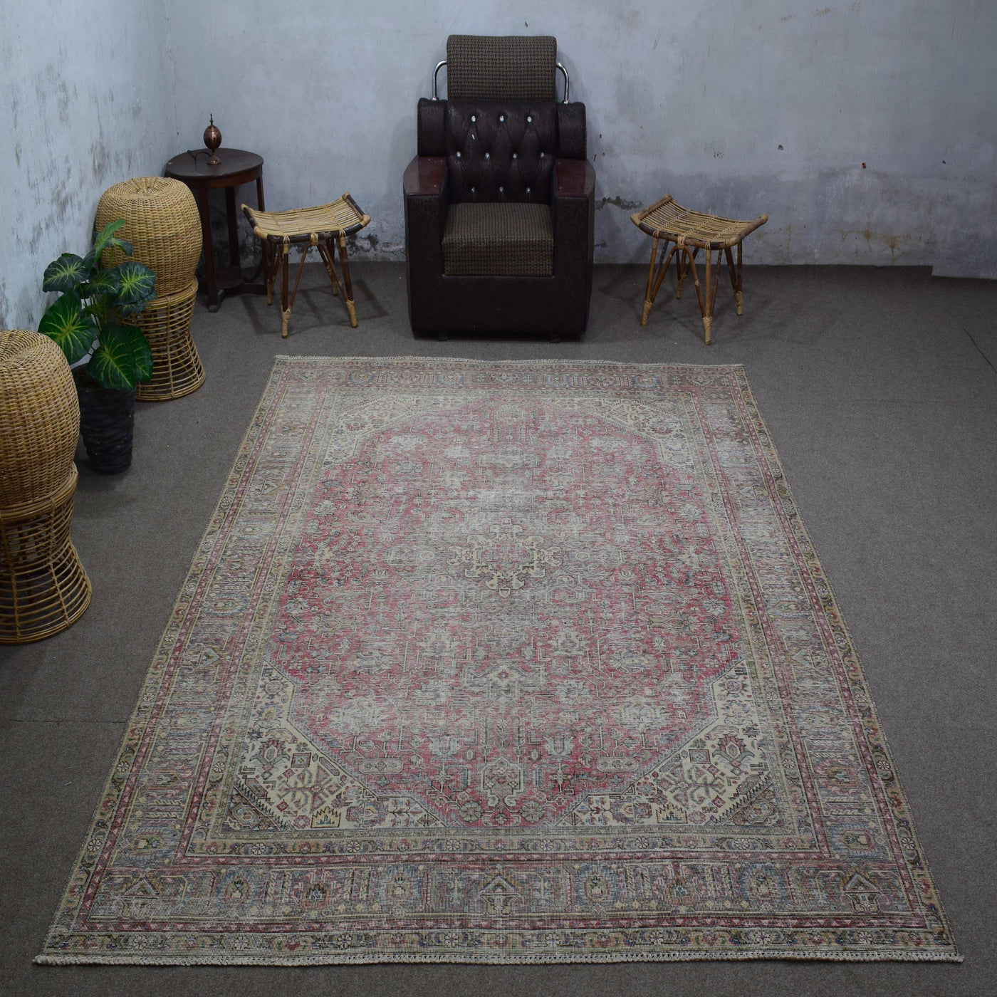 Vintage Persian rug 235x324 cm styled in interior showing soft rose tones and worn medallion design