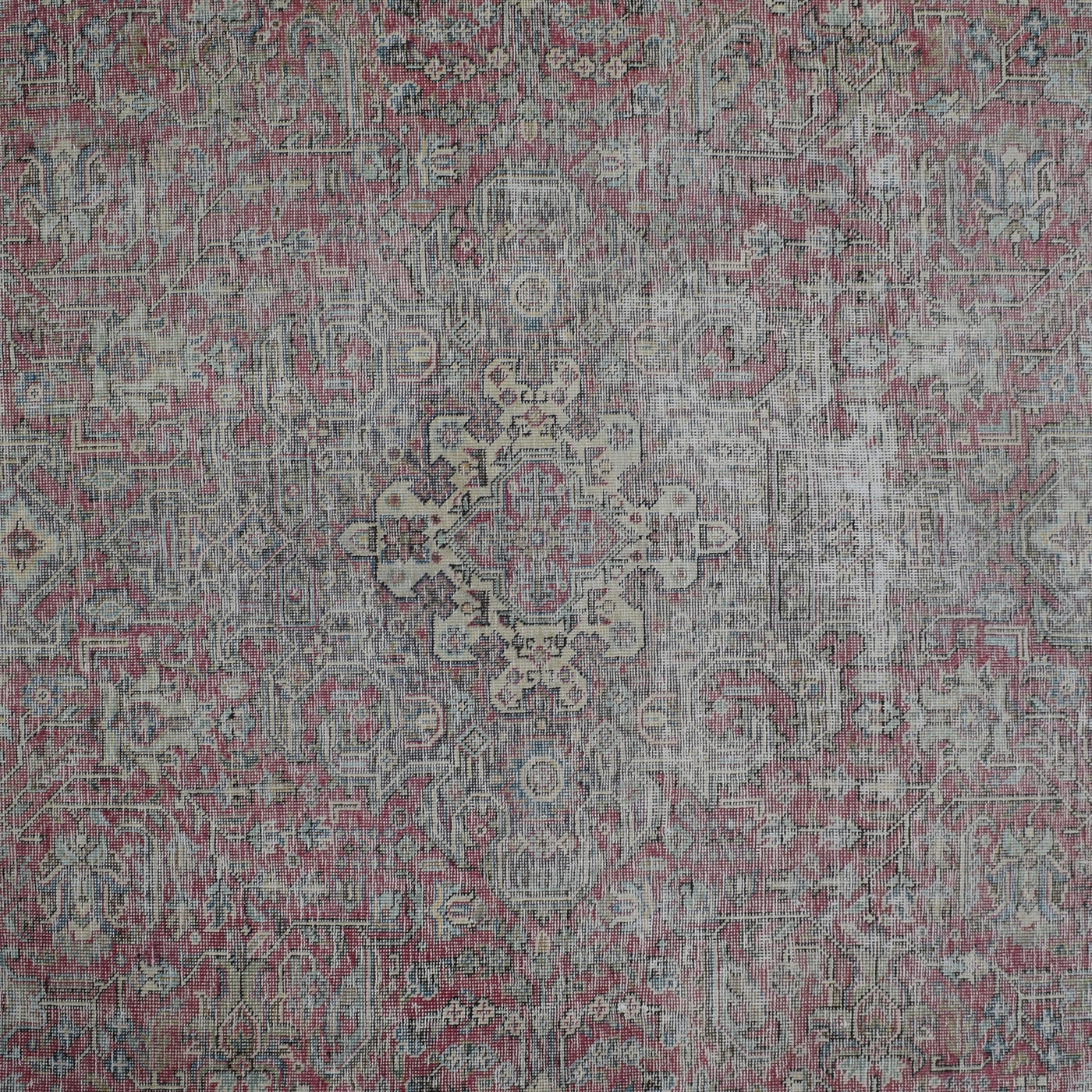 Detailed view of vintage Persian rug pattern featuring delicate medallion and floral elements