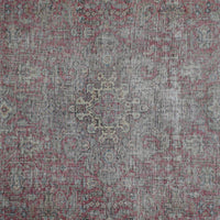 Detailed view of vintage Persian rug pattern featuring delicate medallion and floral elements