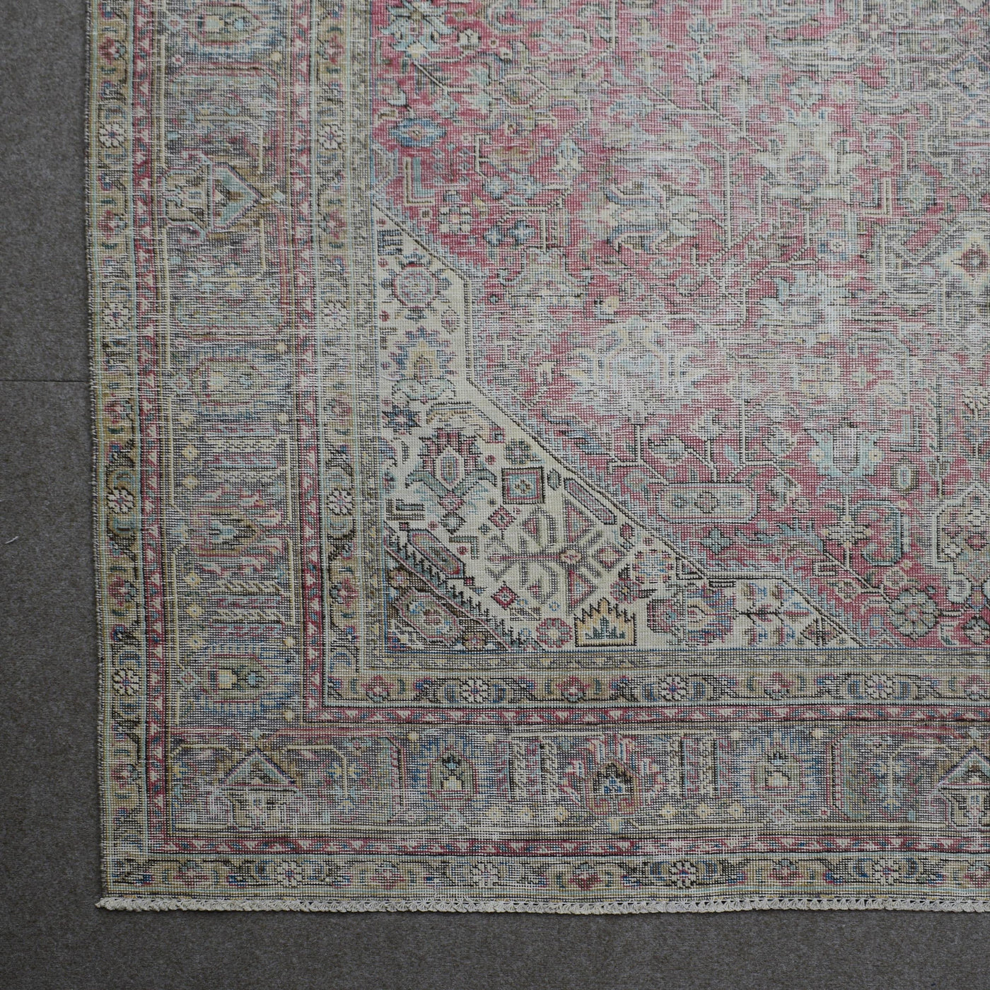 Corner detail of Persian rug with decorative border and traditional Persian motifs