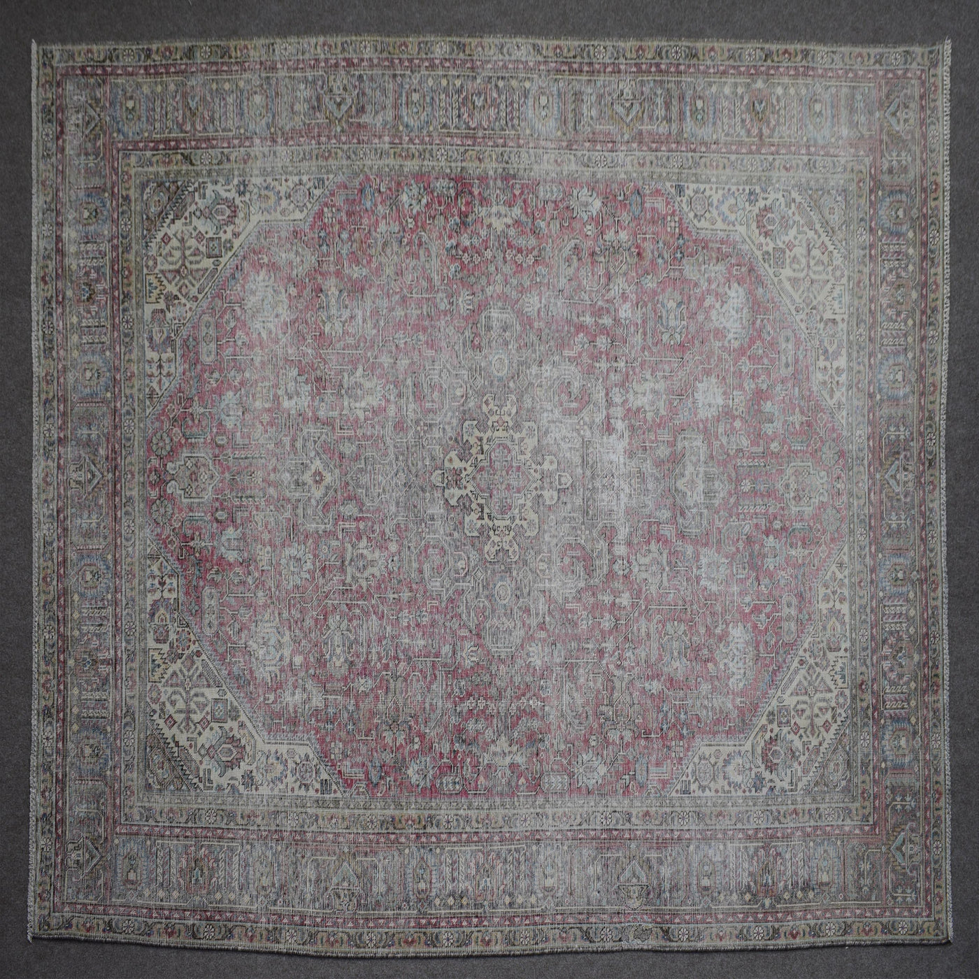 Close up of Persian rug border with colorful floral motifs and intricate guard stripes