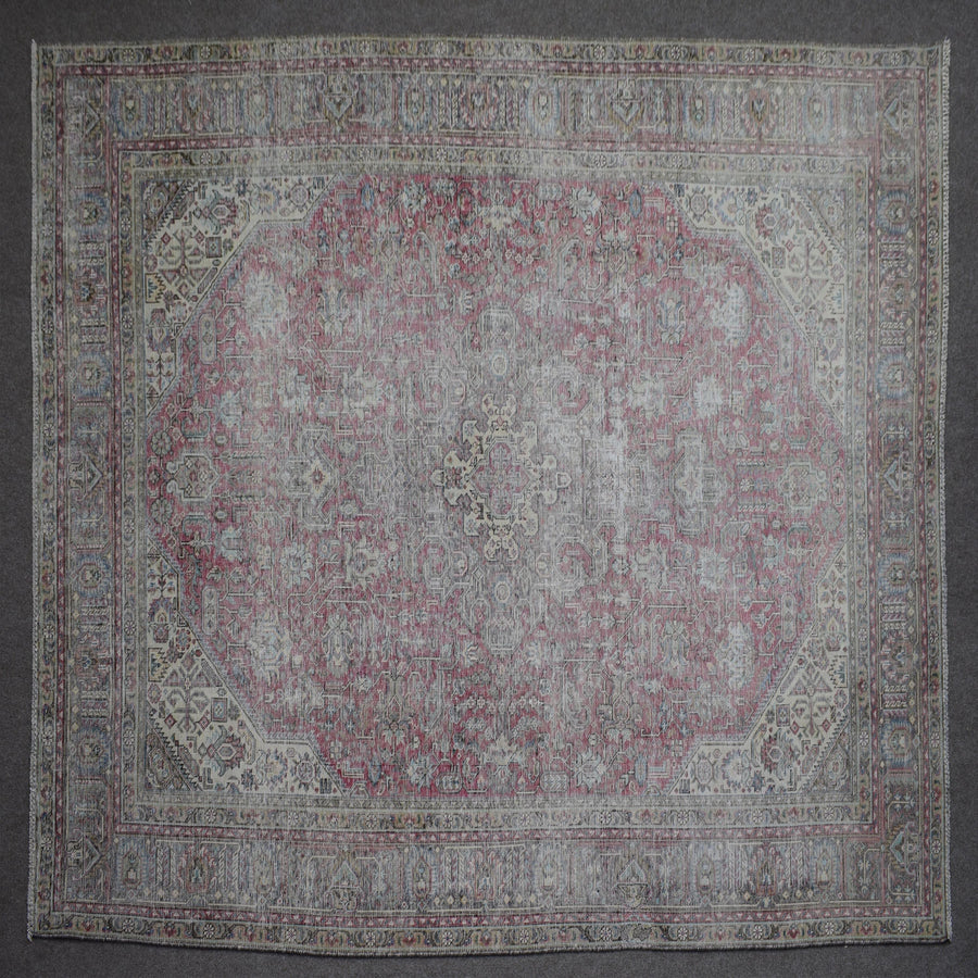 Close up of Persian rug border with colorful floral motifs and intricate guard stripes