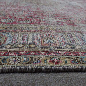 Macro detail of Persian rug pattern highlighting worn wool texture and faded design