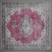 Close up of Persian rug border with colorful floral motifs and intricate guard stripes