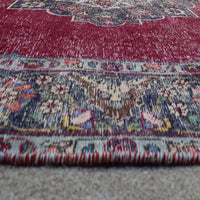Macro detail of Persian rug medallion highlighting dense floral elements and wool texture