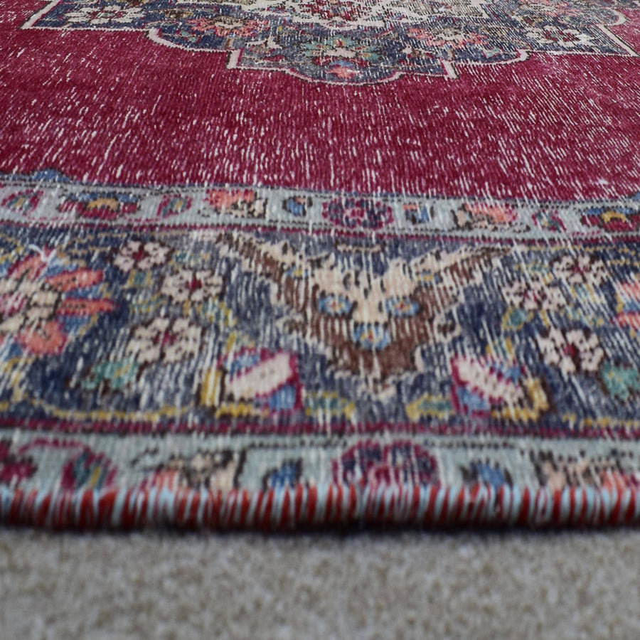 Macro detail of Persian rug medallion highlighting dense floral elements and wool texture