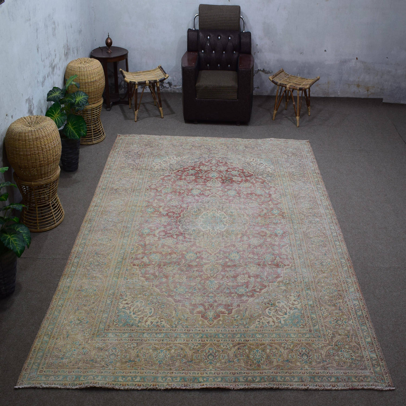 Vintage Persian rug 251x348 cm styled in interior showing soft ivory tones and worn floral design